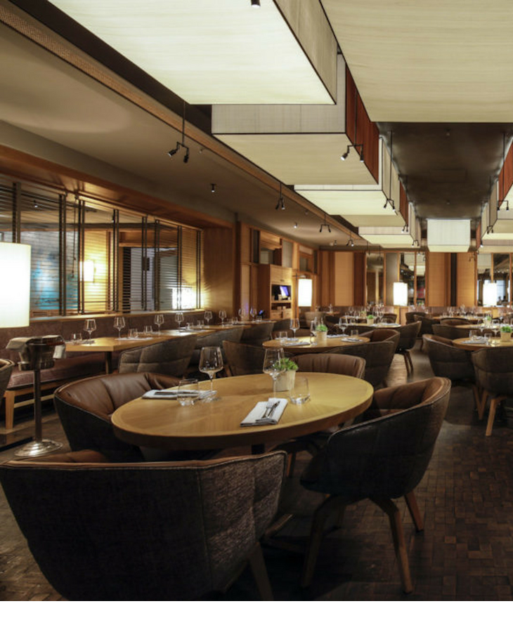 Elegant LOUIS Hotel restaurant with booth seating for corporate dinners and networking events.