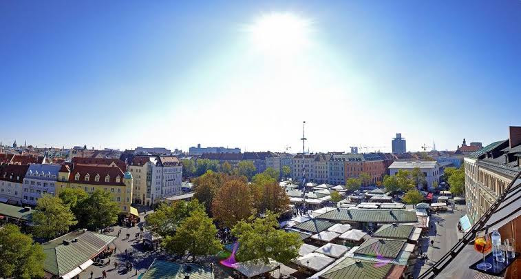 Outdoor venue at LOUIS Hotel Munich: classic marketplace setting for street-fair event activations.