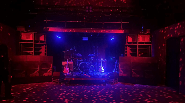 Main Hall stage at Club Cheek with blue lighting for live music event entertainment showcase.