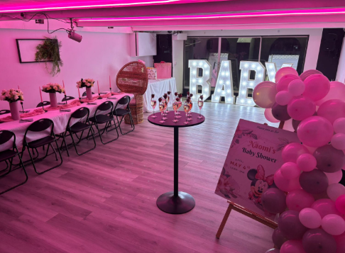 Private baby shower in No.22 Kitchen & Bar with pink lighting and marquee letters.