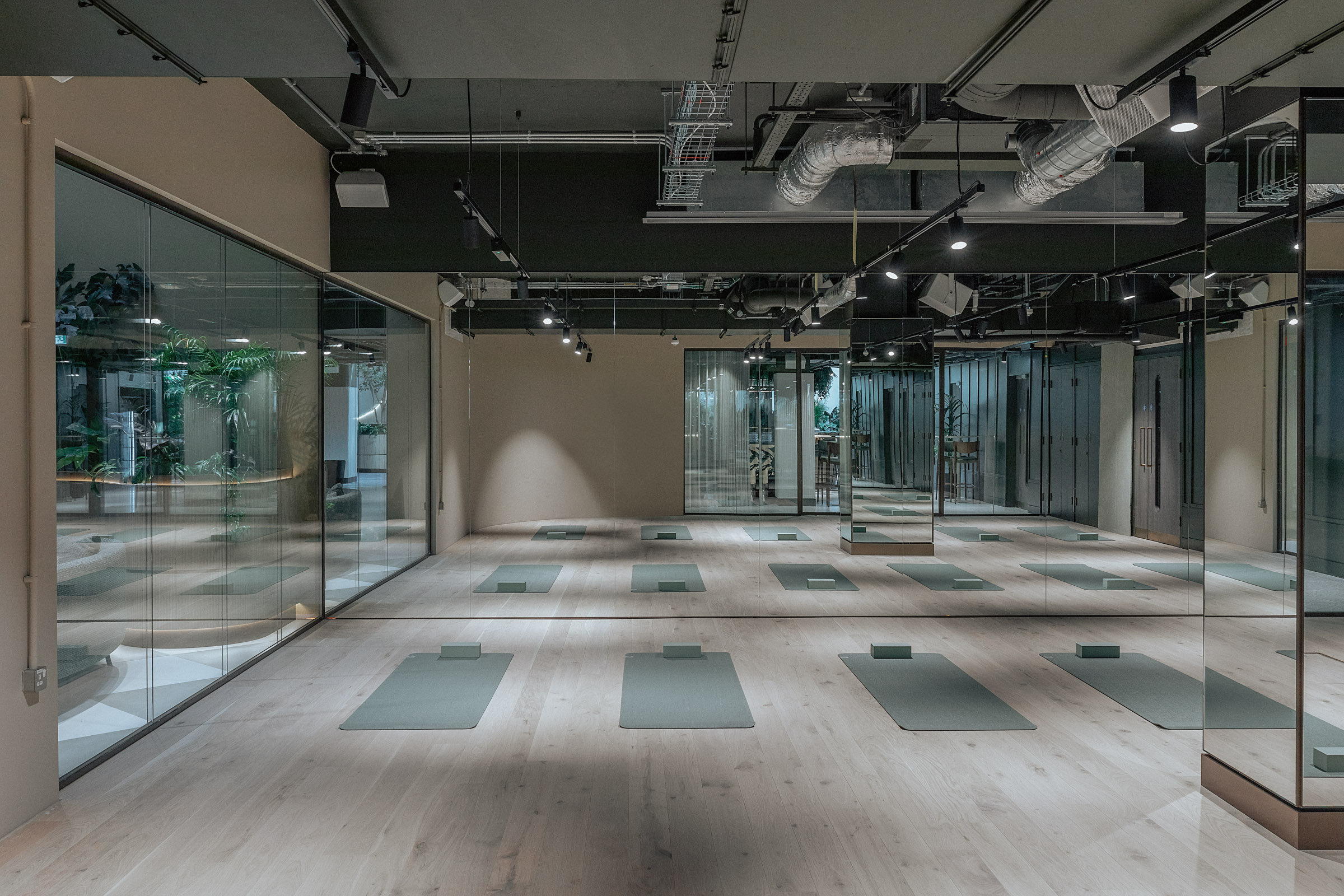 Modern wellness studio with hardwood floors, perfect for workshops and meetings.