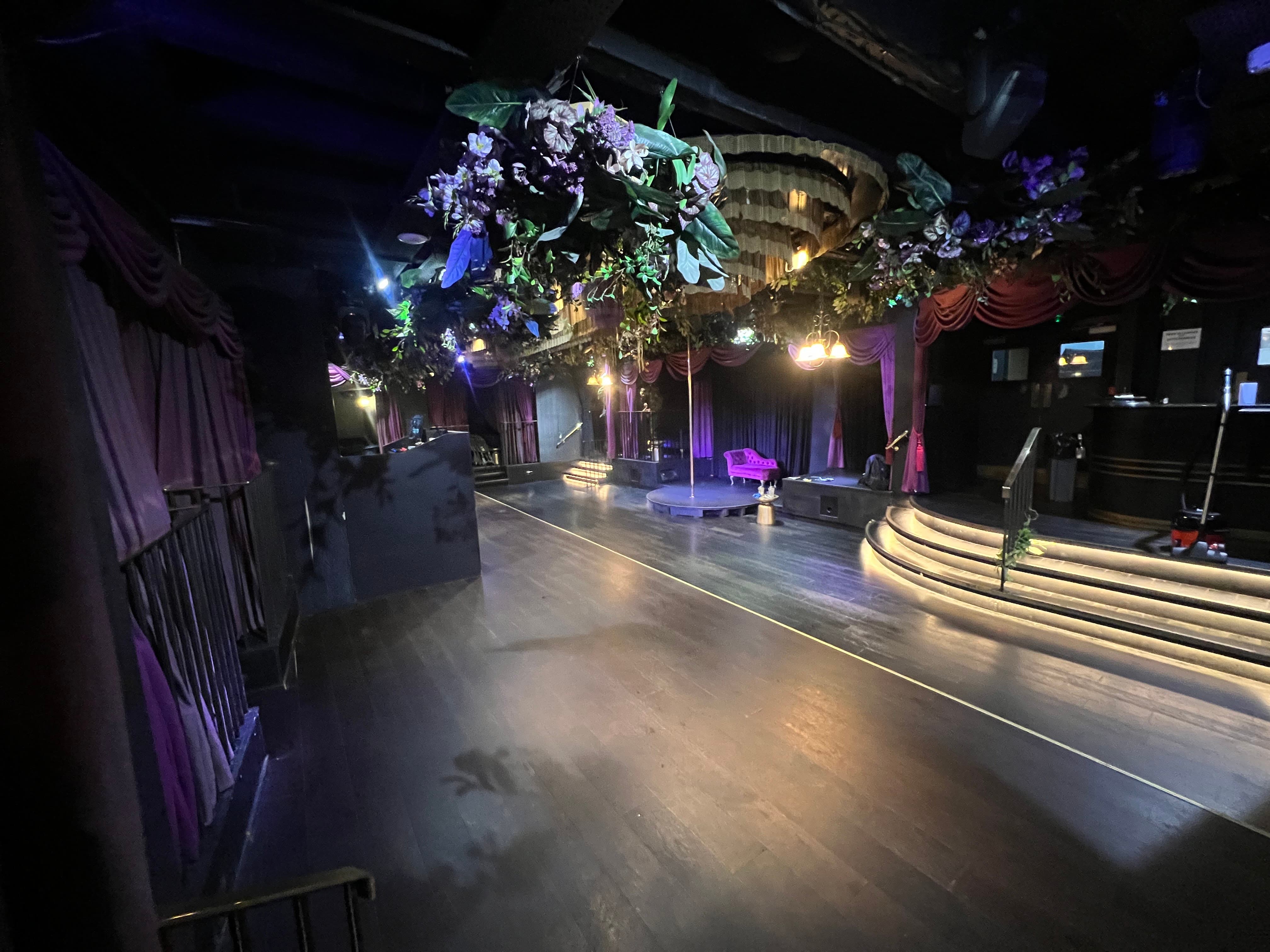 Themed Soho venue with stage and floral decor for brand activations and nightlife events.