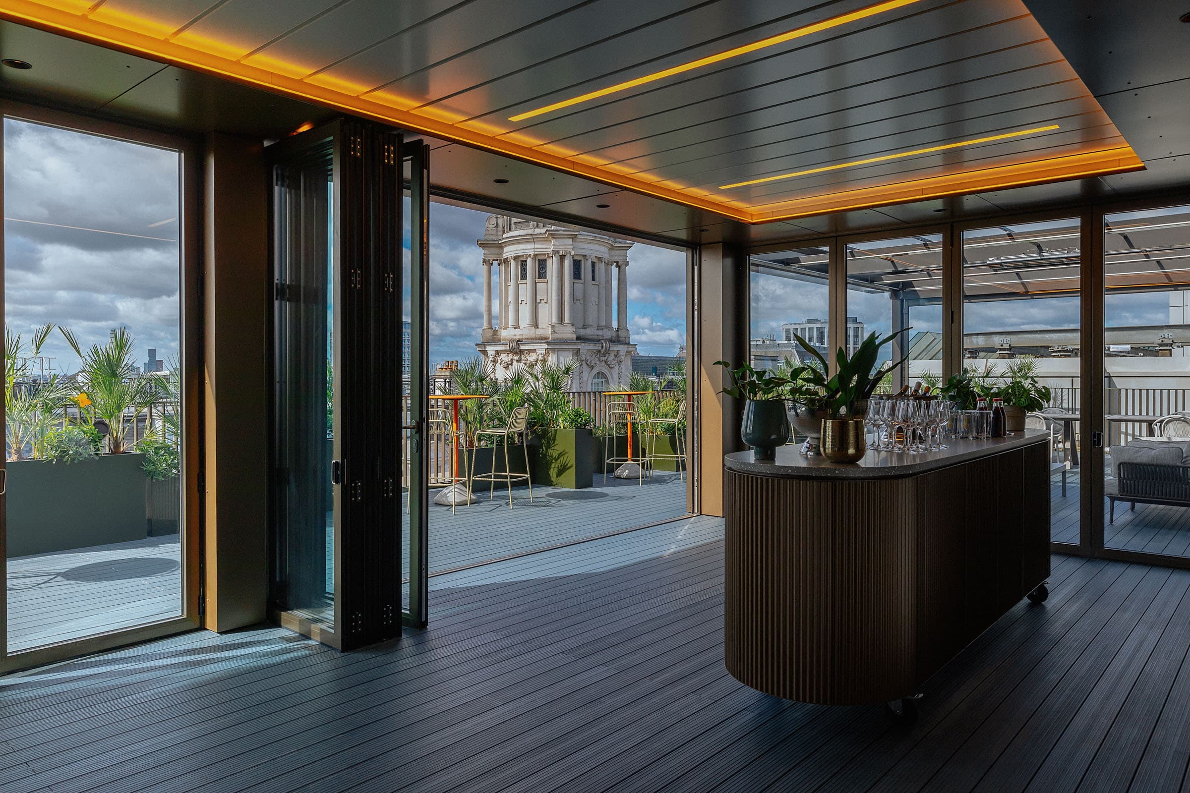 Central London rooftop event space with panoramic views and stylish bar for networking.