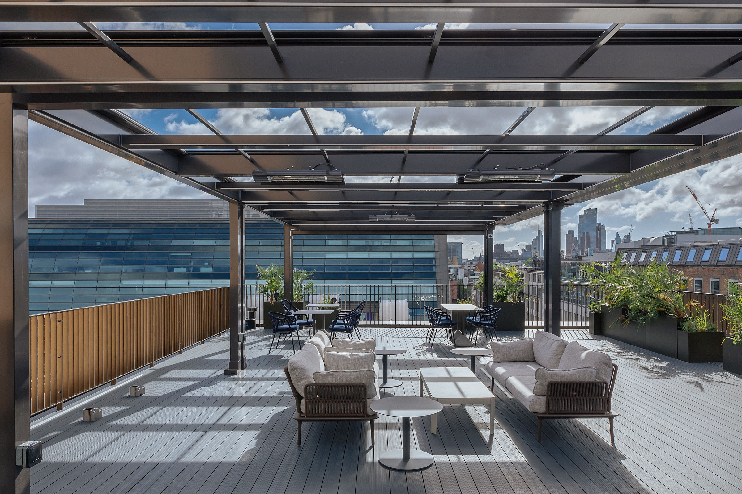 Stylish Central London rooftop event space with panoramic city views and modern furnishings.