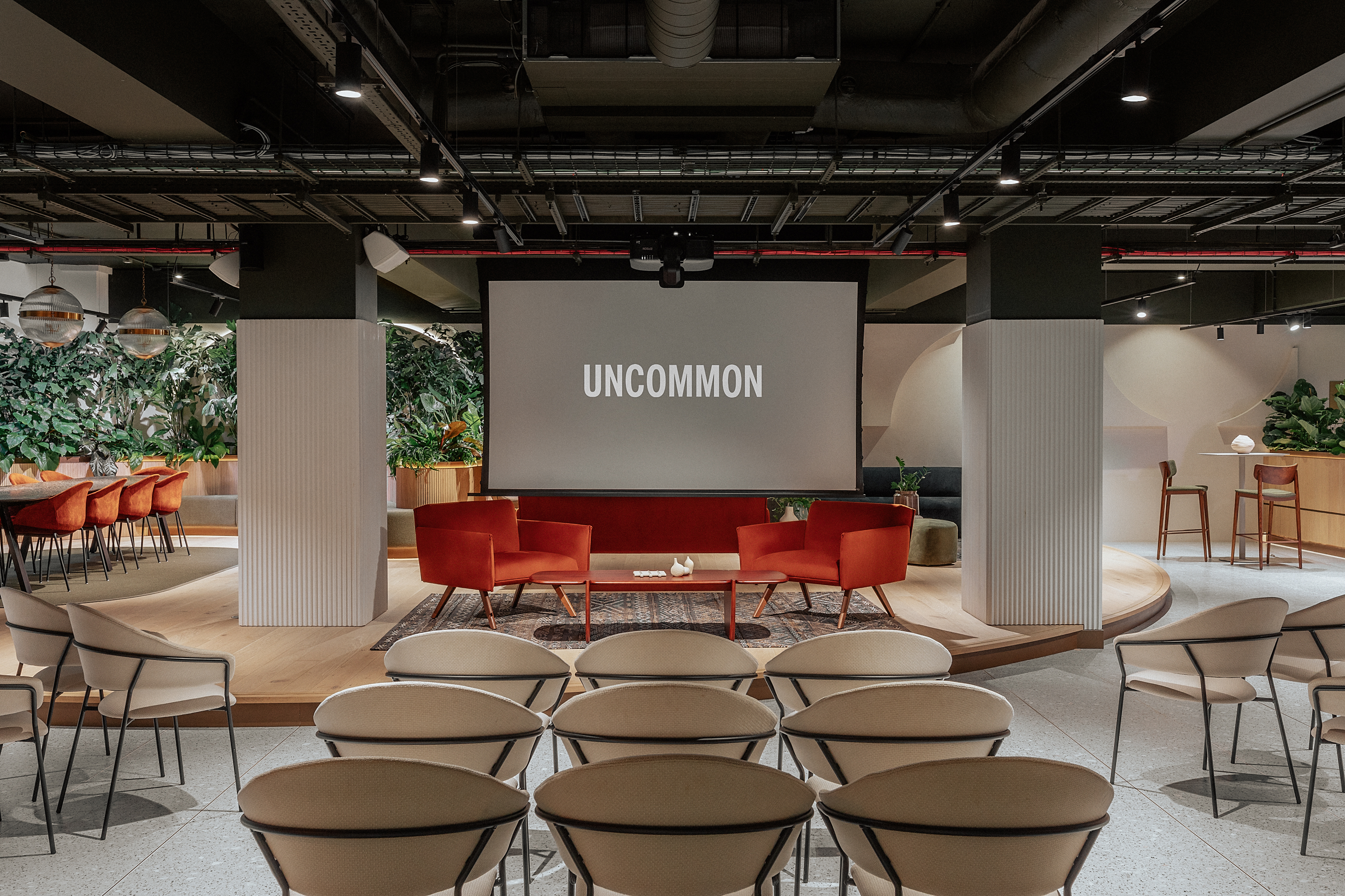 Central London event space with vibrant red chairs, ideal for workshops and conferences.