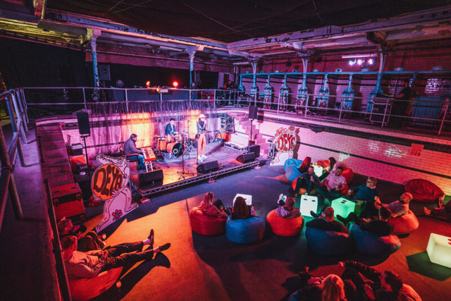 Victoria Baths Females Pool: industrial-chic event venue with beanbag seating for live entertainment.