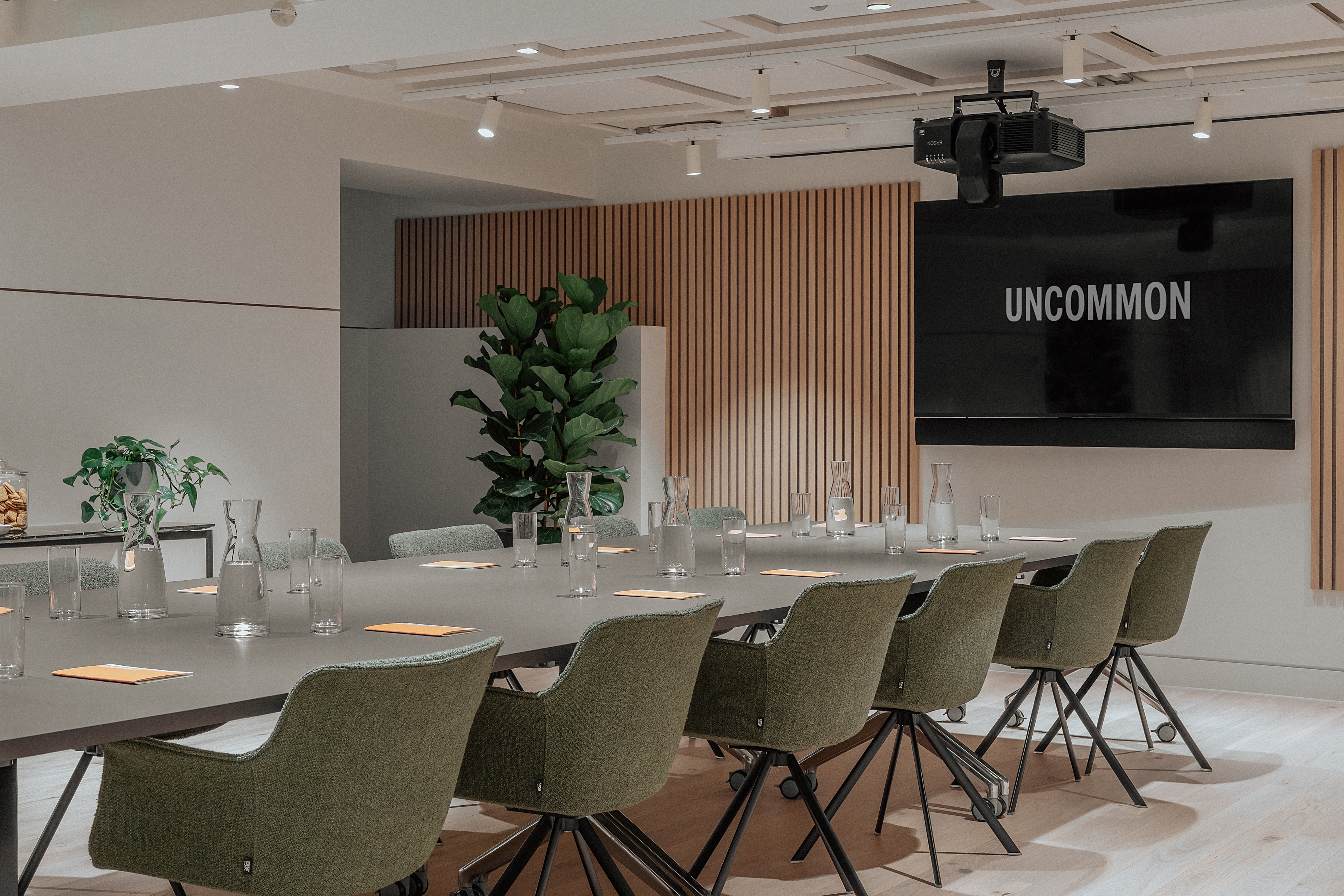 Modern meeting room with long table and comfy seating at Uncommon Holborn for collaboration.