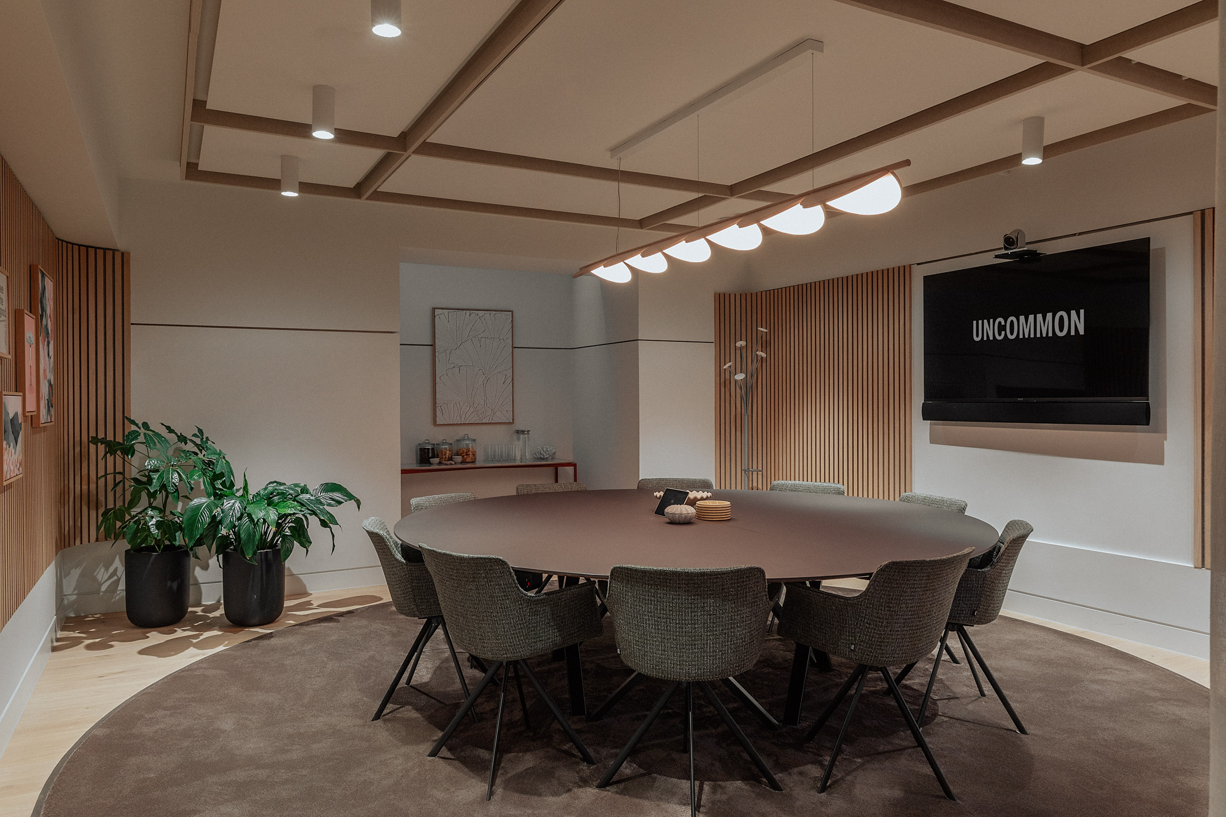 Modern Meeting Room 6 with round table for collaborative corporate meetings.