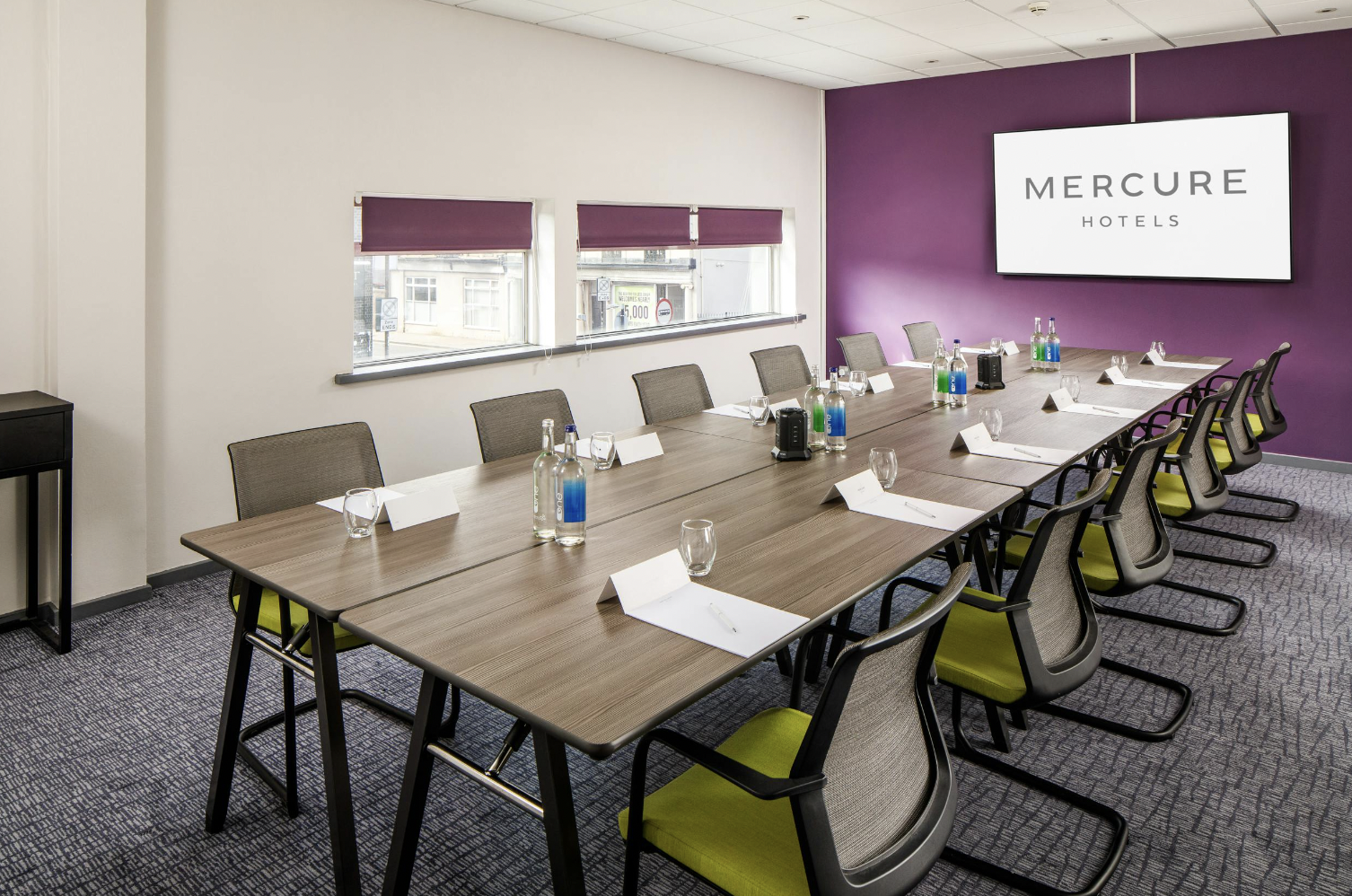 Boardroom-style County Suite at Mercure Bedford with natural light for professional meetings.
