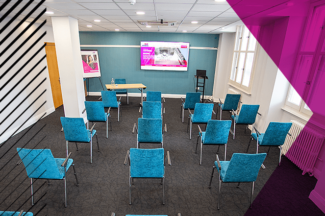 Modern conference room in Broadway House with teal chairs for workshops and meetings.