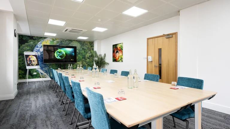 Modern meeting room in Broadway House with aqua chairs, ideal for collaborative events.