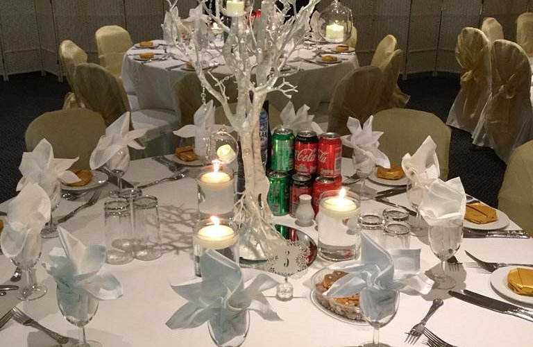 Elegant dining setup with white decor for weddings and celebrations in The Penridge Suite.