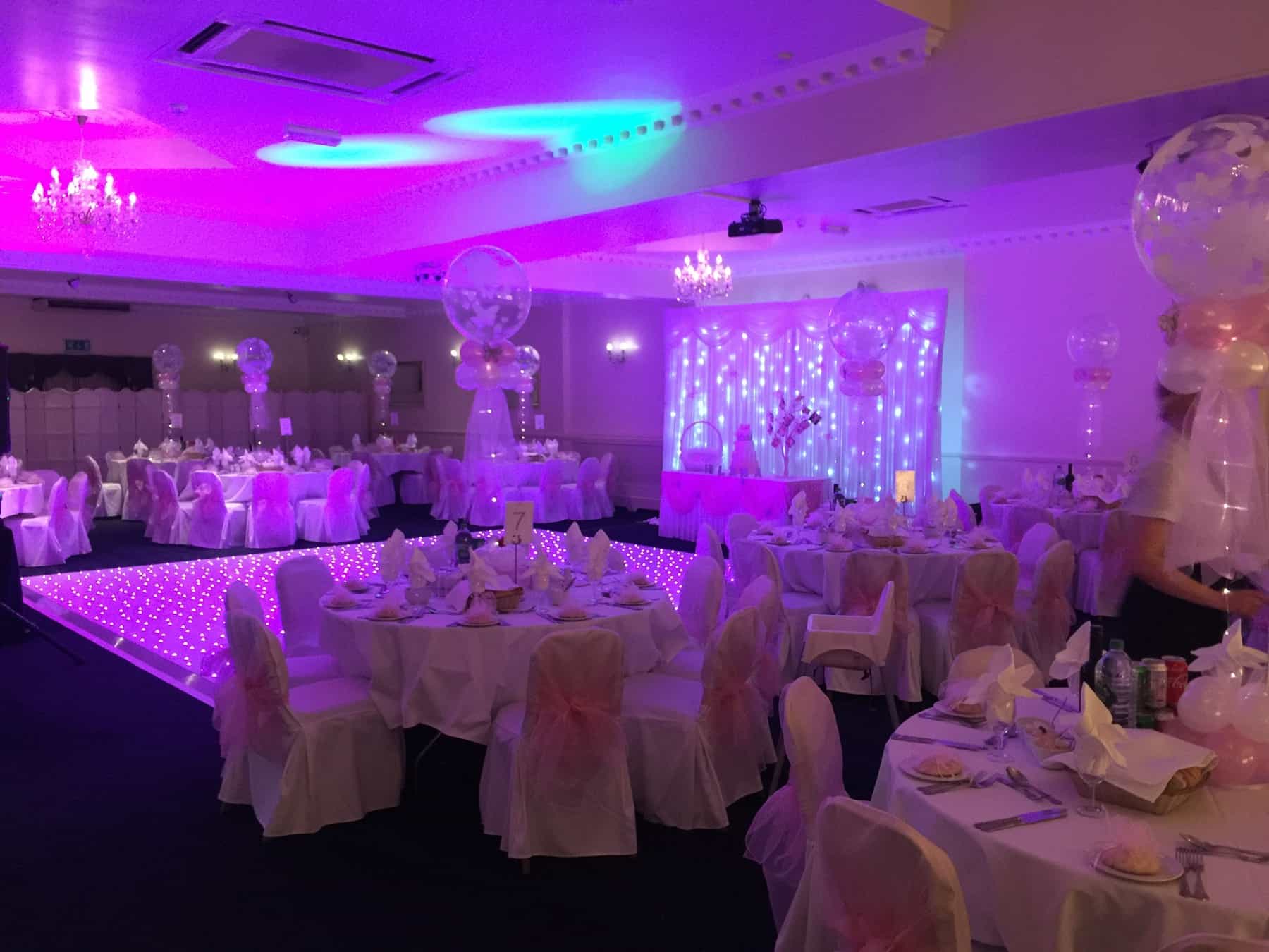 Elegant event space with pink lighting for celebrations in The Penridge Suite.