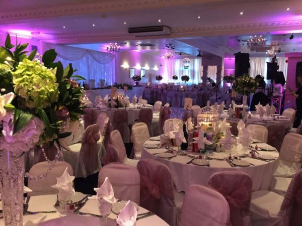 Elegant banquet hall with soft purple lighting, ideal for weddings and formal gatherings.