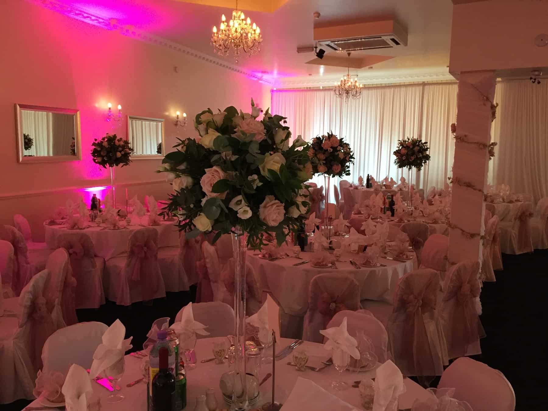 Elegant banquet hall with floral centerpieces, perfect for weddings and formal events.