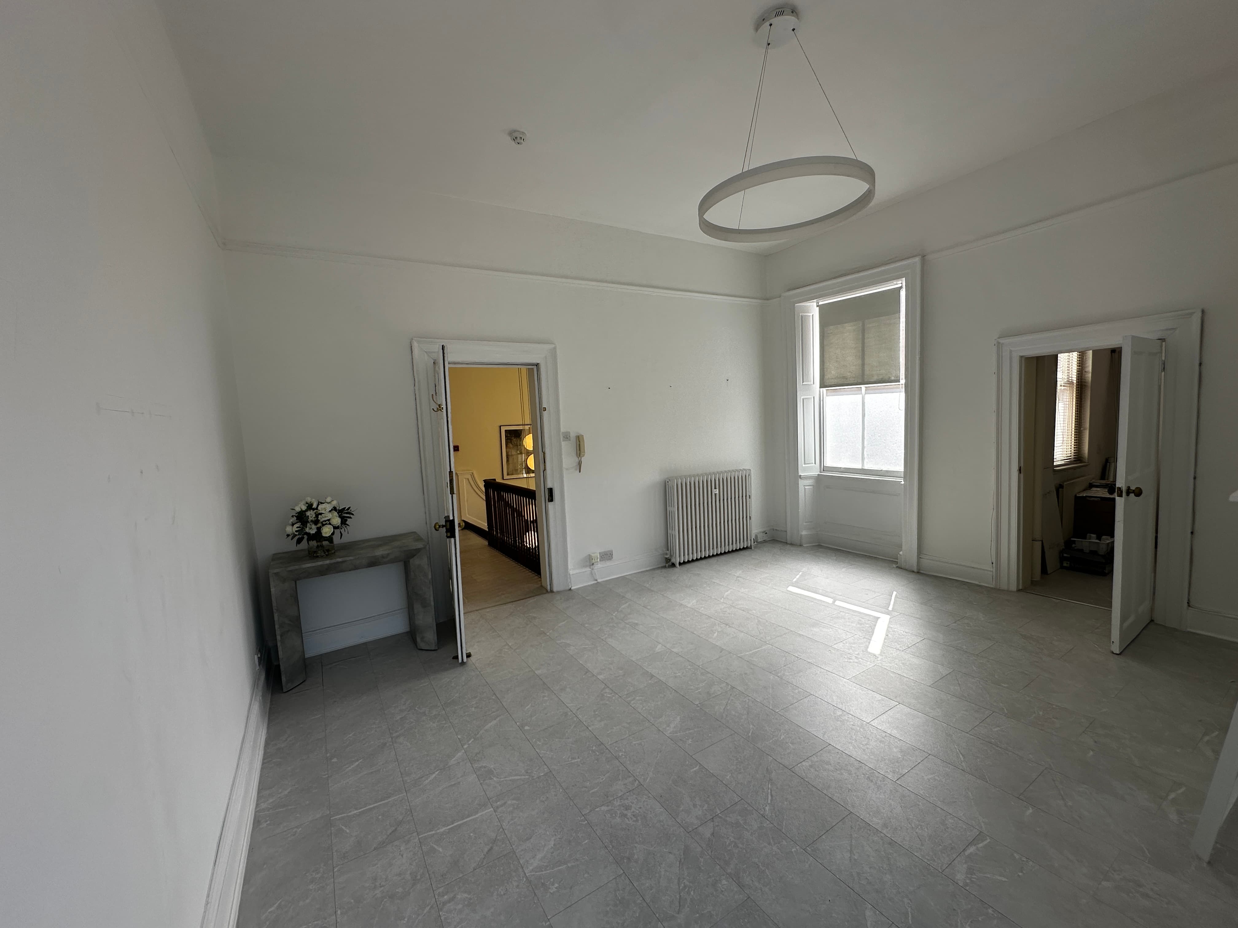 Minimalist meeting space with blank-canvas layout, perfect for corporate events and workshops.