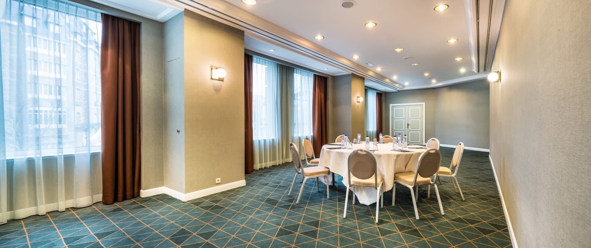Bright Brussels conference center with round table setup for workshops and gatherings.