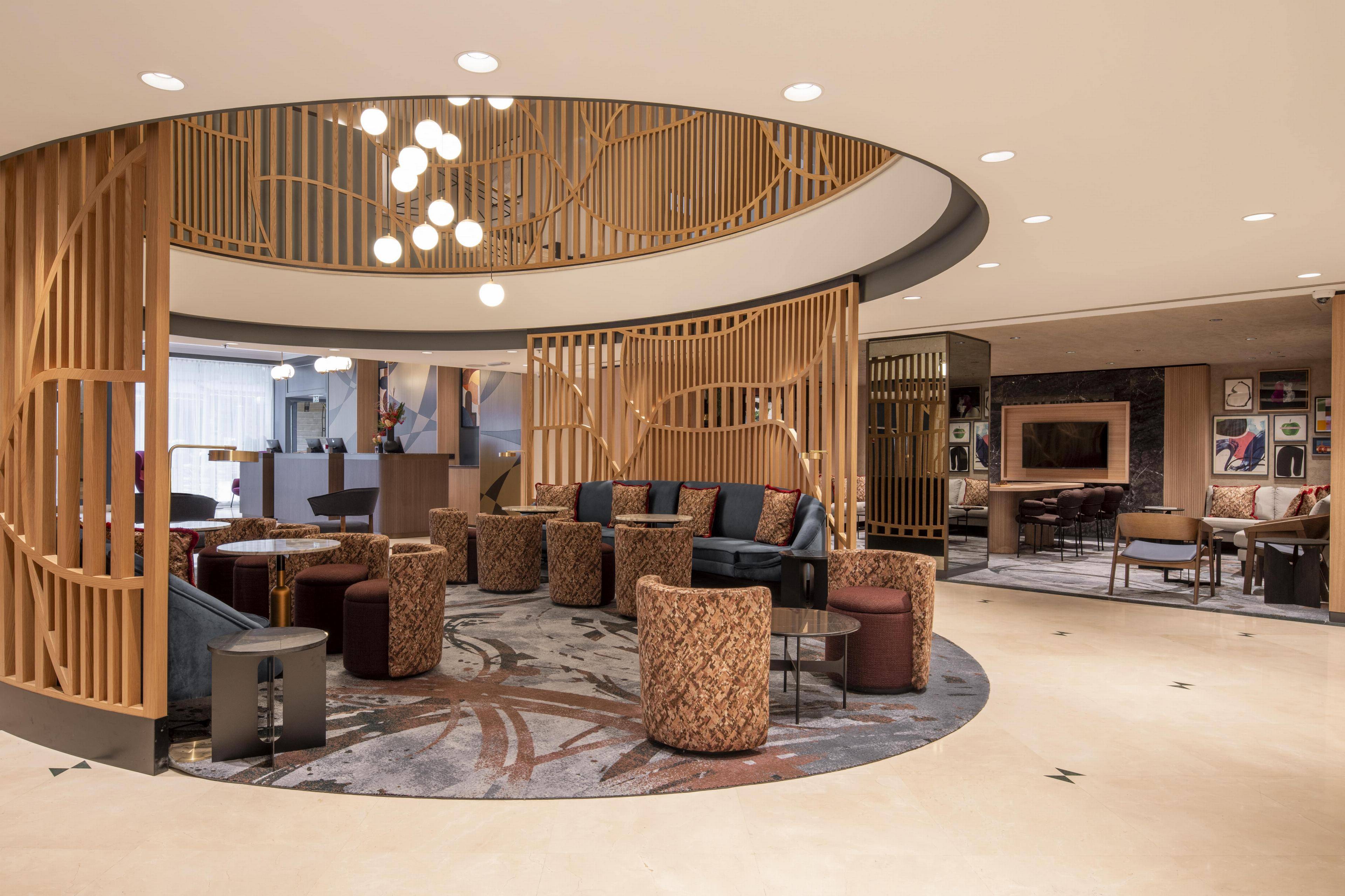 Stylish lobby at Brussels Marriott Hotel for events and meetings, featuring elegant decor.