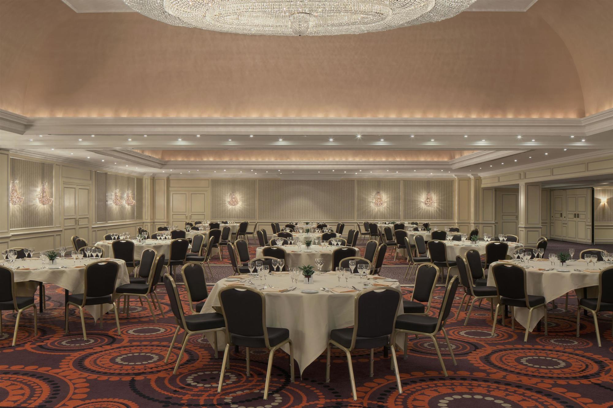 Elegant Senne Ballroom with round tables, perfect for weddings or corporate events.
