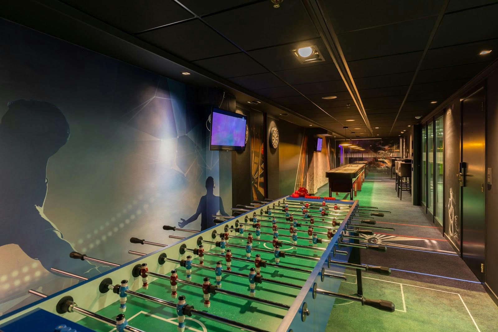 Vibrant Thon Hotel Brussels event suite with foosball table for networking and team-building.