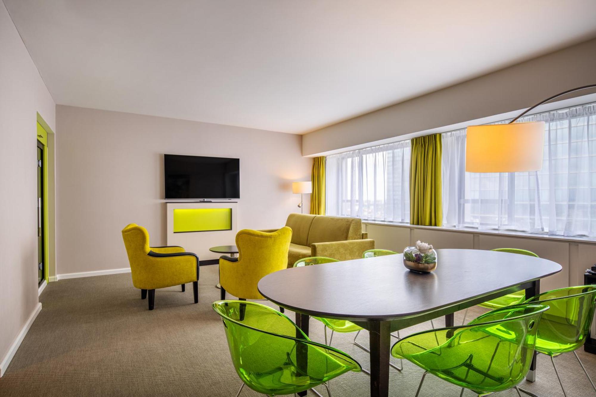 Modern meeting suite at Thon Hotel Brussels with bright colors for workshops and gatherings.