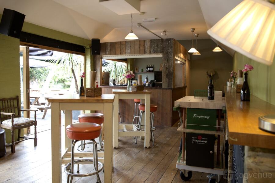 Versatile workshop room with high tables for networking events at The Simon Lau Centre.