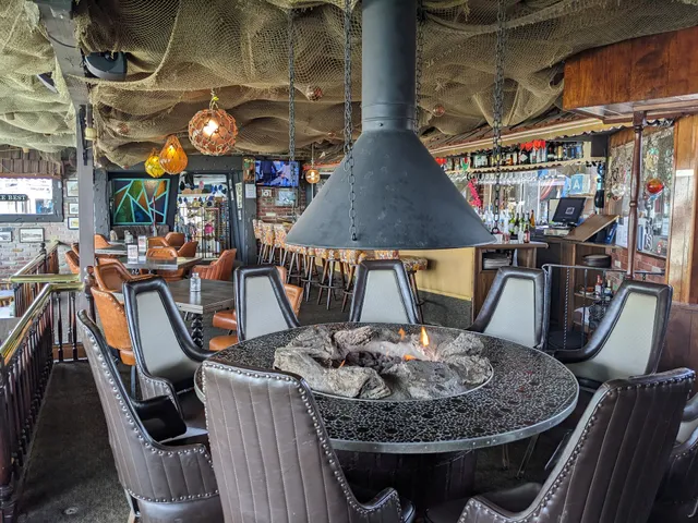 Wildflower Cafe dining space with central fire pit for VIP events and networking socials.