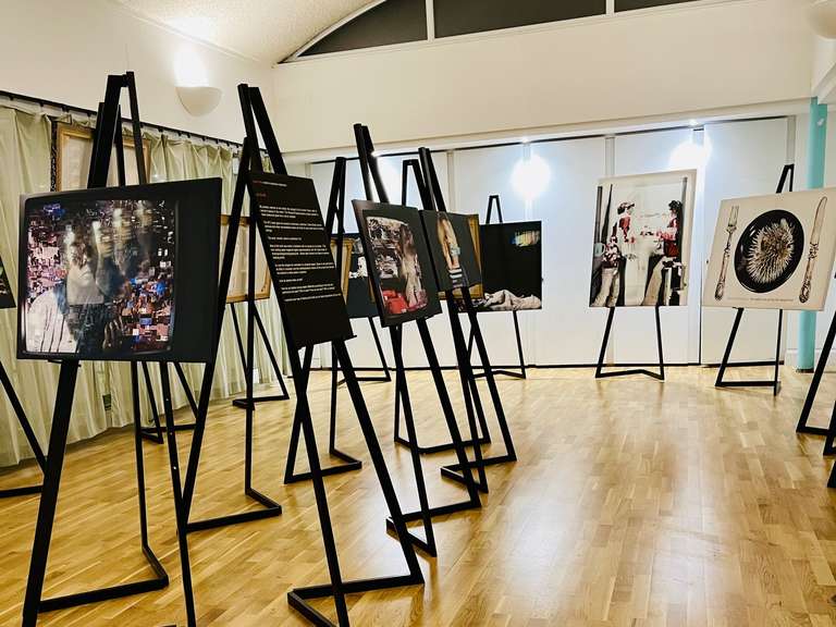 Flexible gallery event space with easel signage, ideal for London community workshops and exhibits.