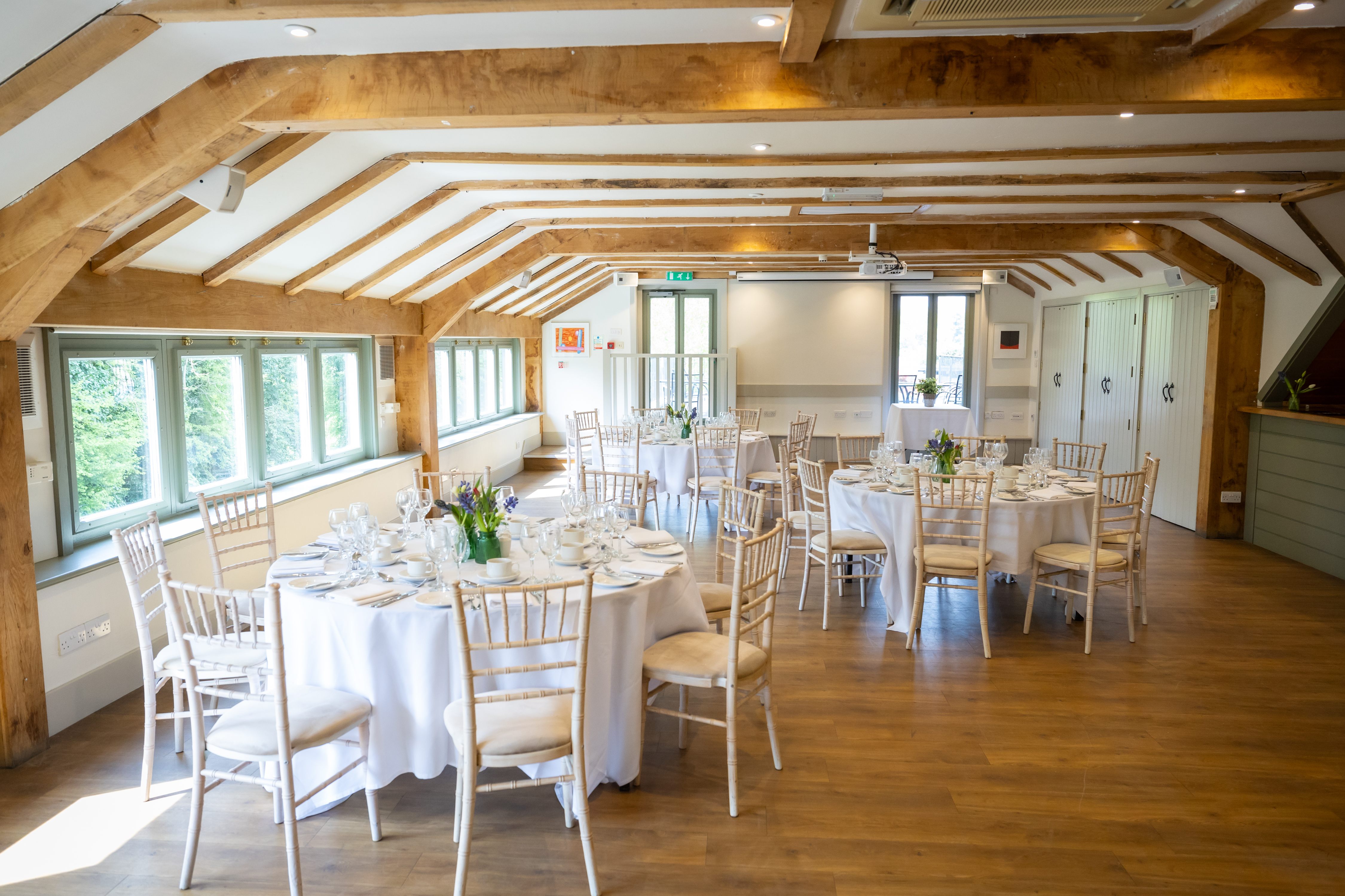 Millstream Room at Tewinbury Farm: elegant event space with rustic beams for gatherings.