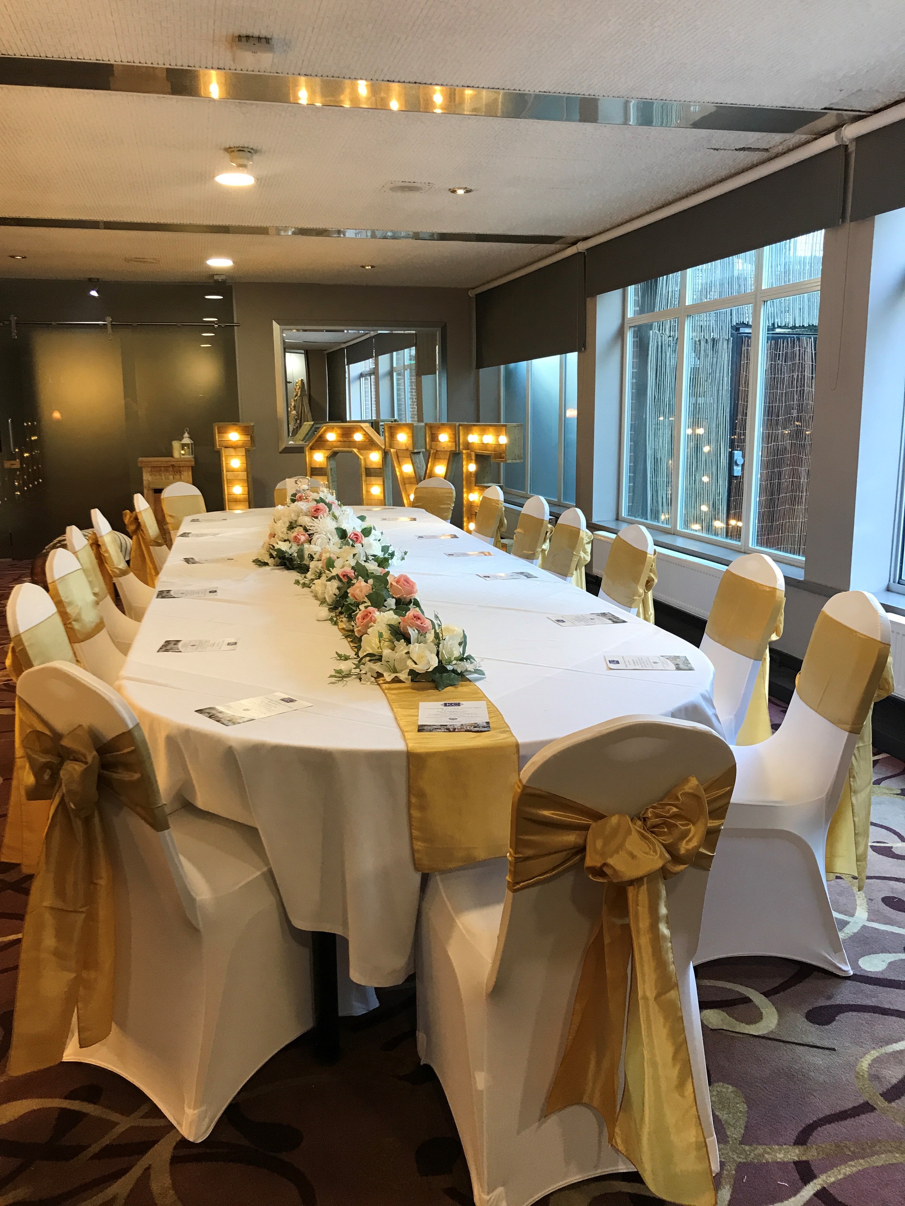 Lenham Suite wedding banquet at Mercure Maidstone with gold accents and LOVE sign.