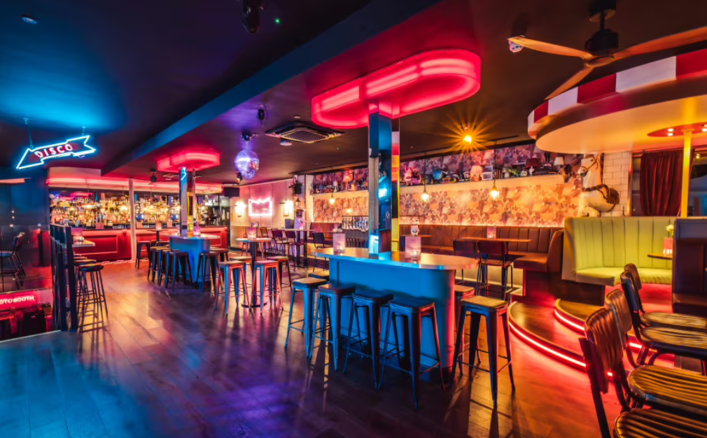 Vibrant event space in Simmons Shoreditch with neon lights for cocktail receptions.
