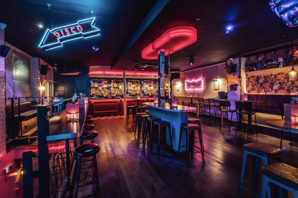 Vibrant nightlife venue hire in Shoreditch with neon bar for parties and mixers.