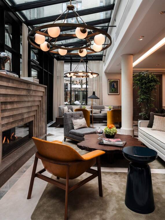 Stylish lounge with fireplace, perfect for networking events in Rosewood Munich.