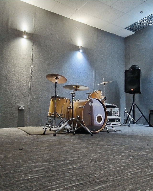 DIO Music Studios rehearsal room with drum kit, ideal for music practice and creative sessions.