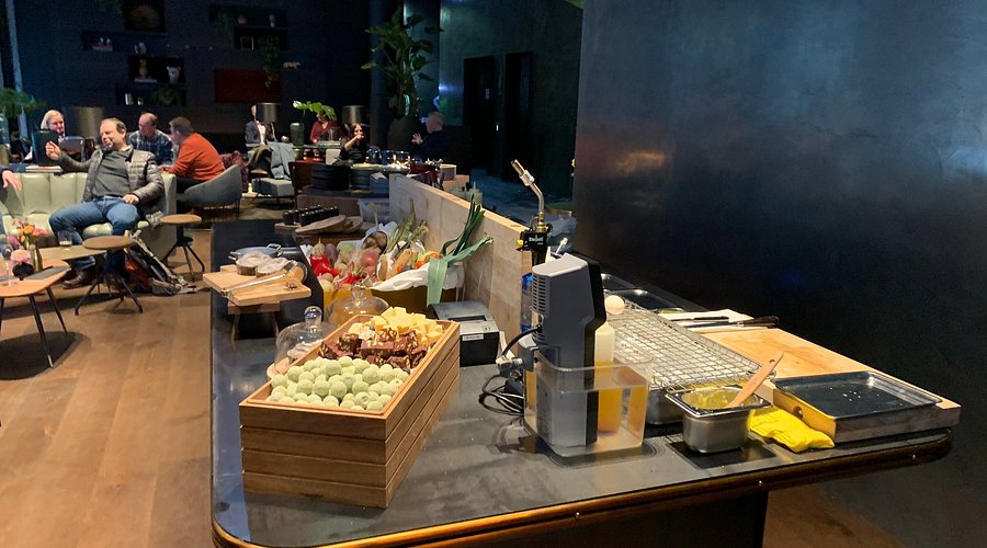 Vibrant networking event at Clarion Hotel® The Hub with stylish bar and snacks.