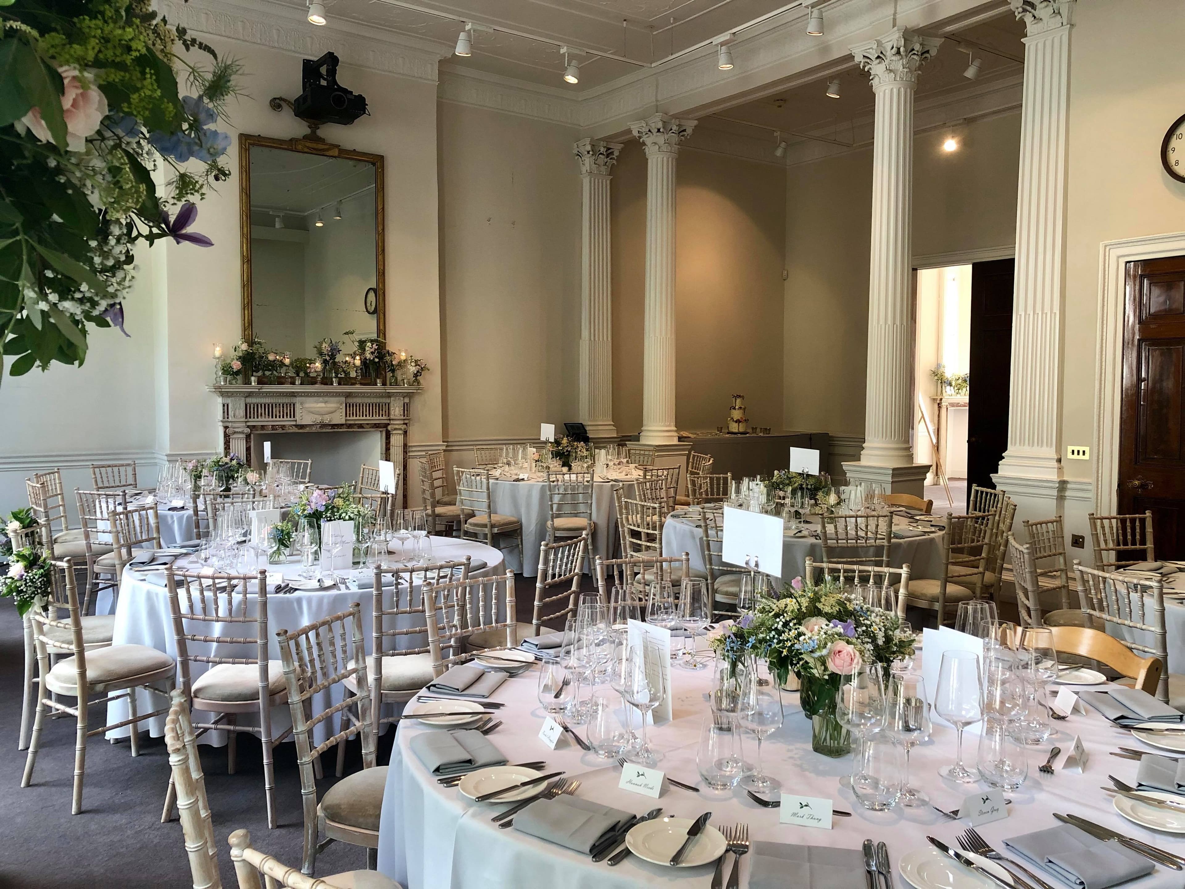 Elegant event space with round tables, perfect for weddings and corporate functions.