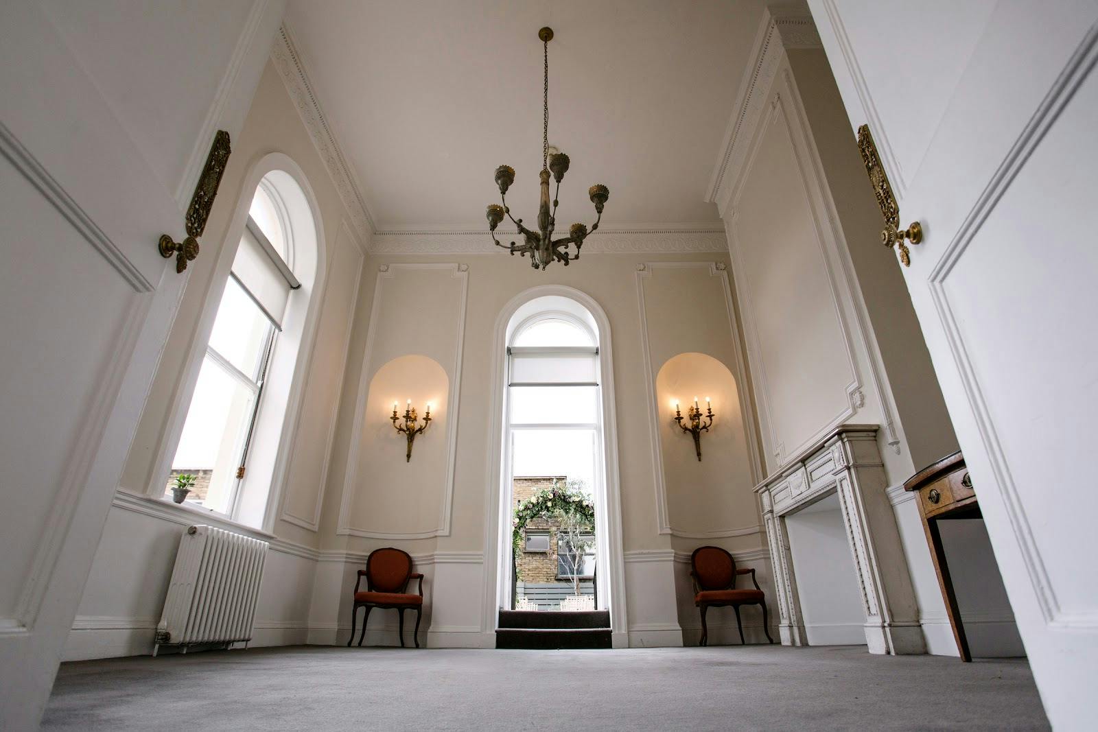 Elegant meeting room with chandelier at John Newsom-Davis Suite, ideal for events.