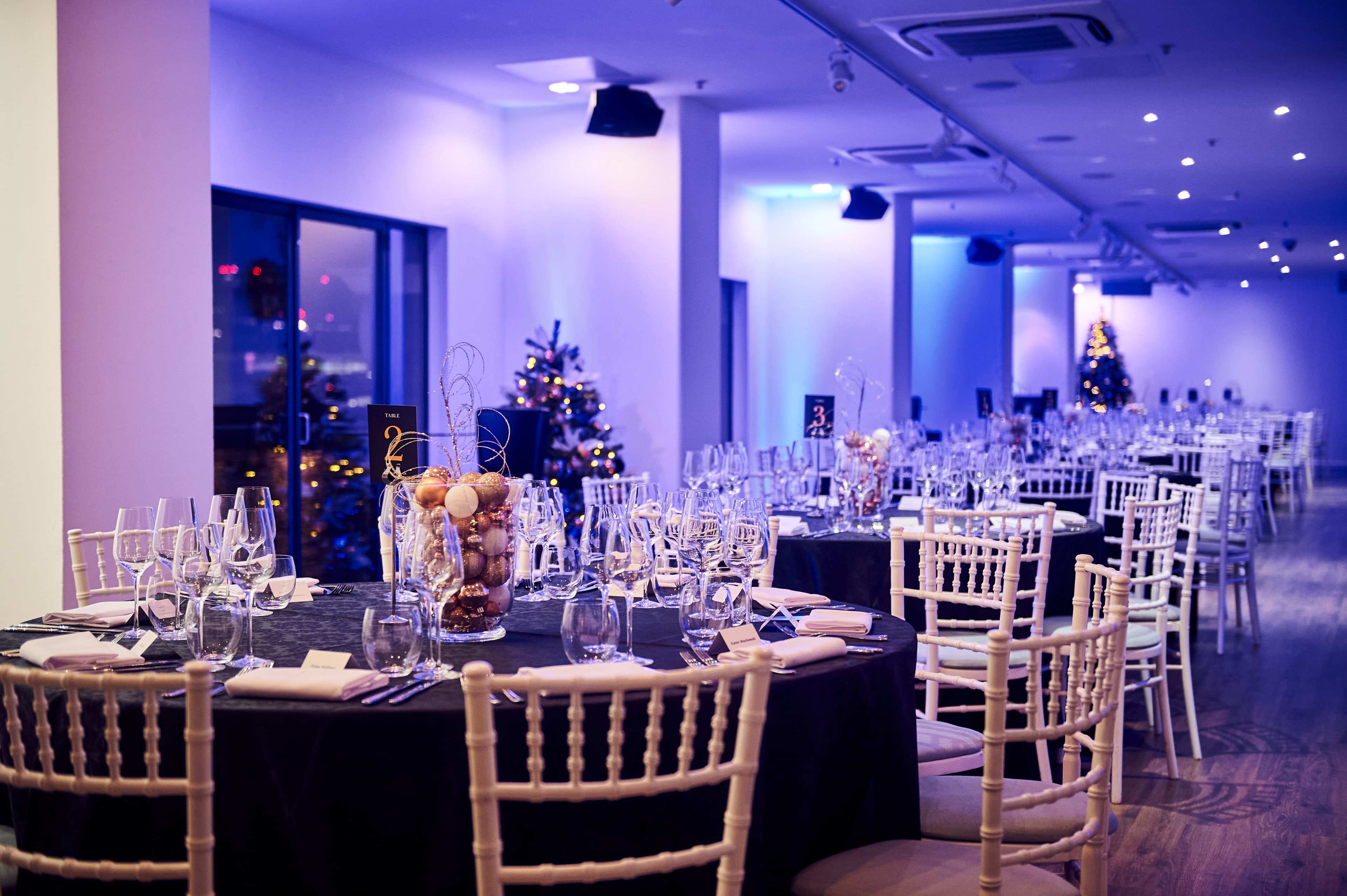 Elegant dining space at OXO2 with black linens, perfect for corporate events and celebrations.