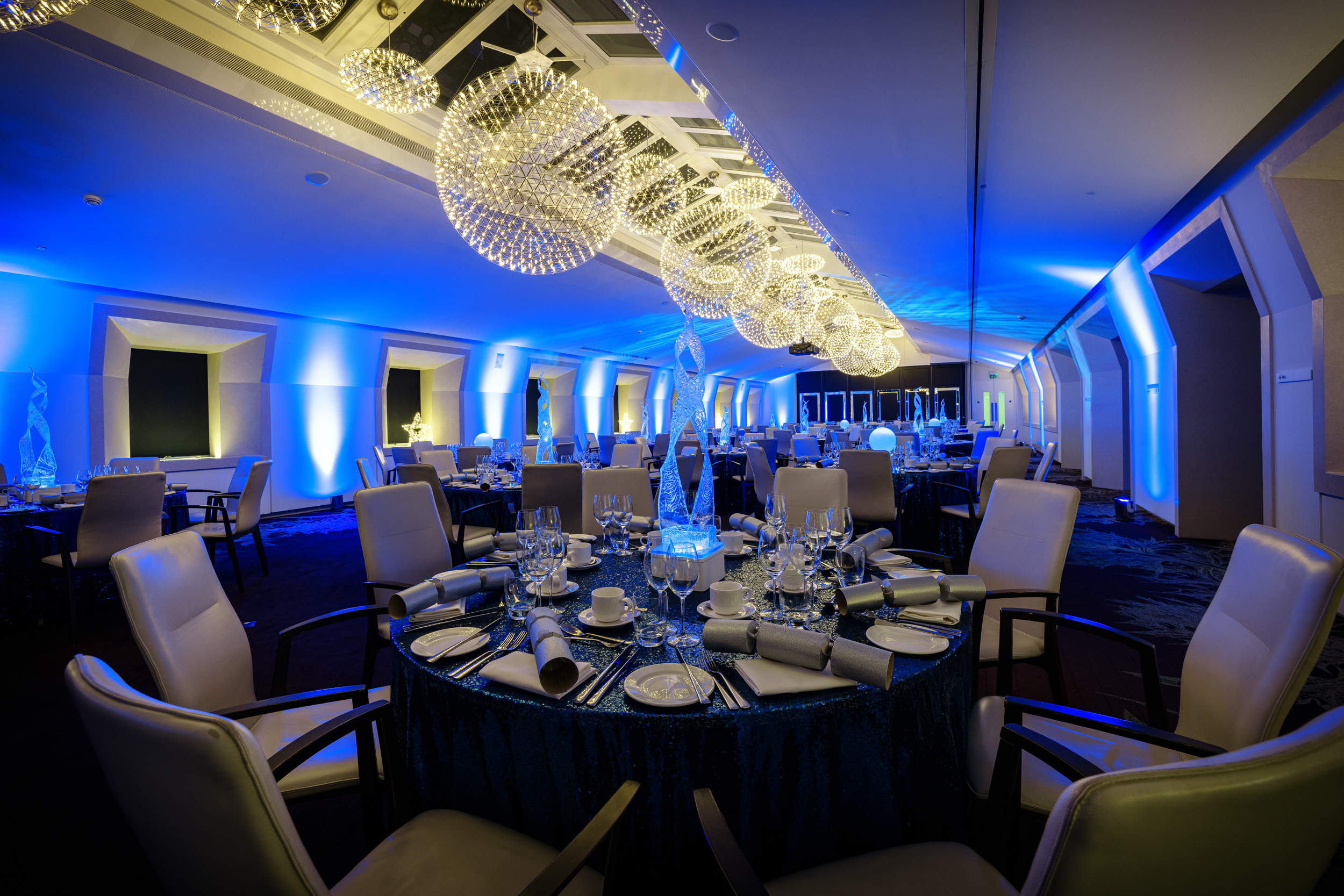 Elegant dinner setup in 30 Euston Square with blue lighting, ideal for corporate events.