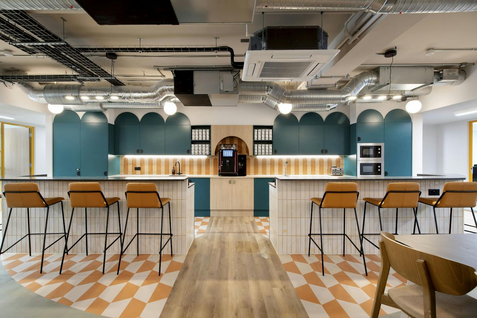 Modern corporate breakout space with coffee service for networking and workshops.