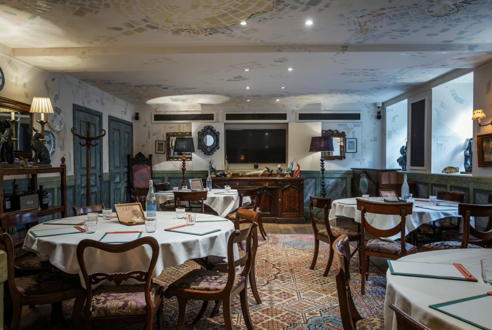 Charming event space with round tables and vintage decor for gatherings at The Zetter Clerkenwell.