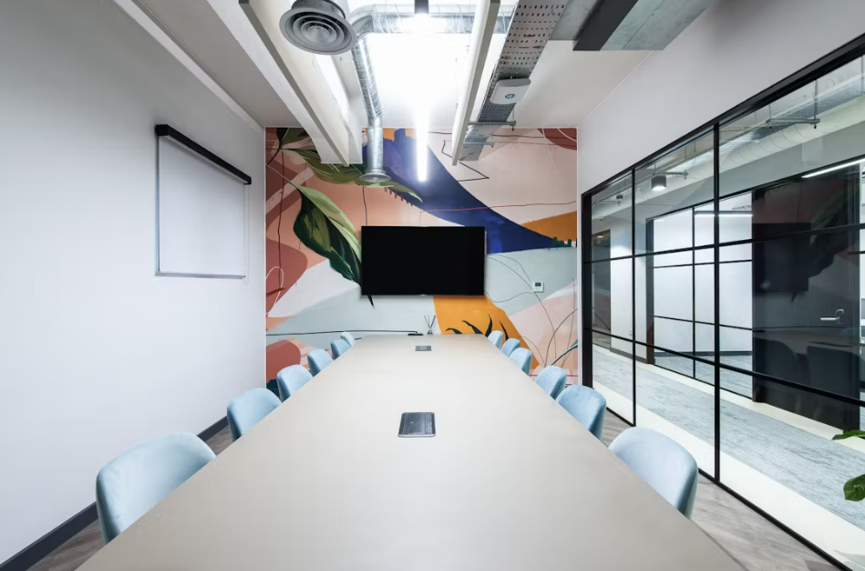 Modern meeting room in Runway East London, featuring a vibrant mural for creative events.