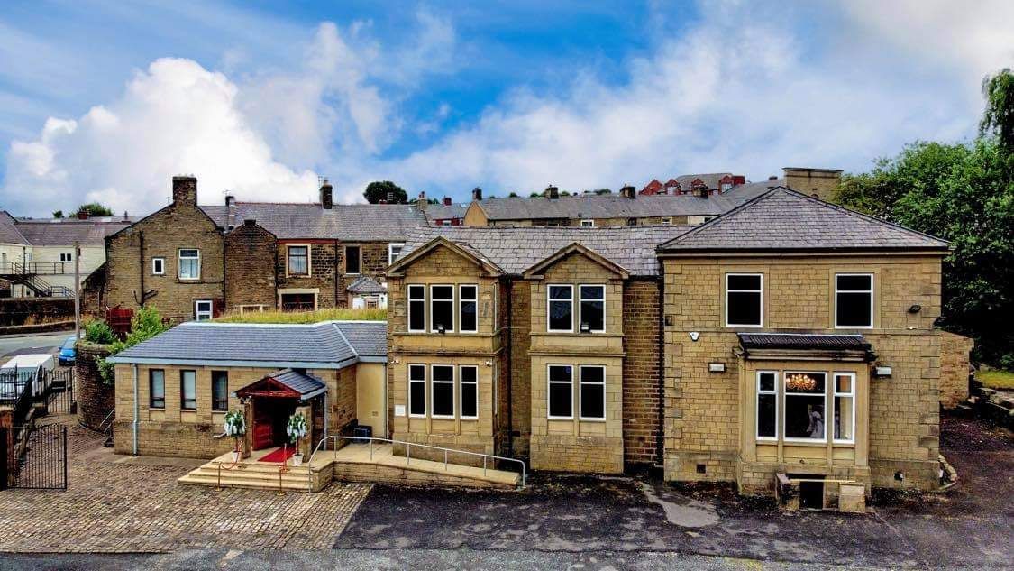 Historic Mill House stone venue with red carpet entrance for boutique meetings and private events.