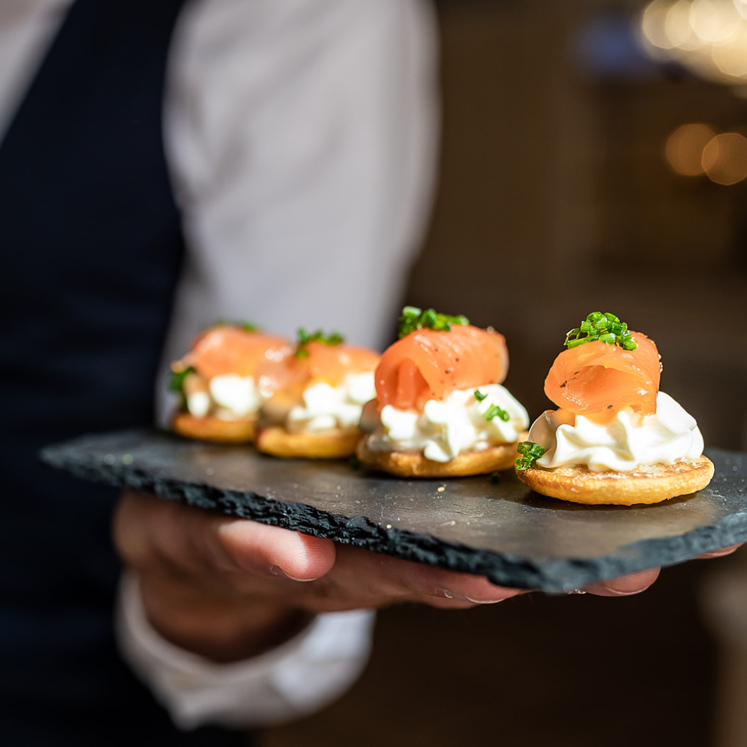 Smoked salmon blinis on slate at The Mill House for cocktail reception or networking mixer.