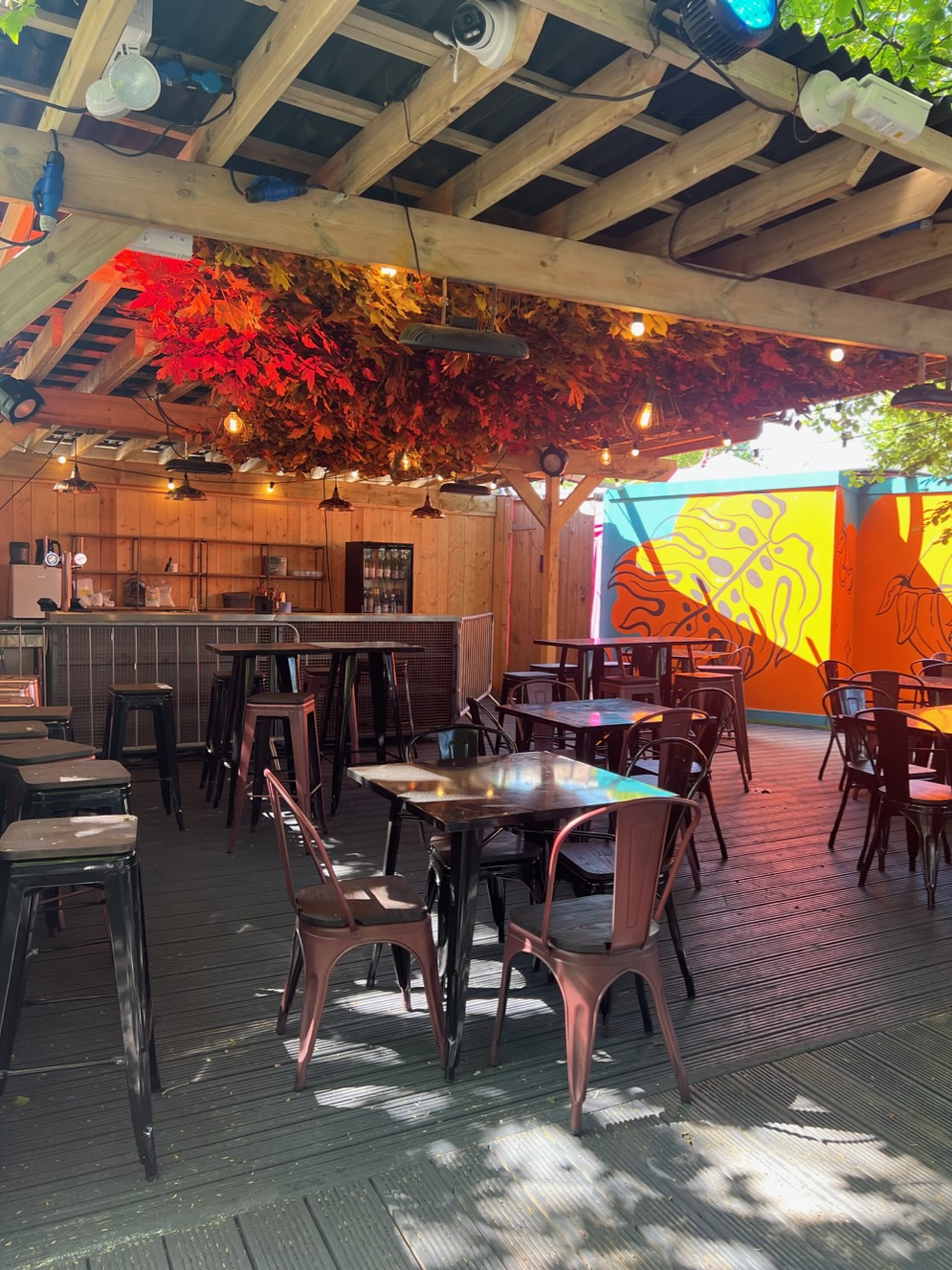 Vibrant outdoor event space with rustic decor, ideal for networking and team-building.