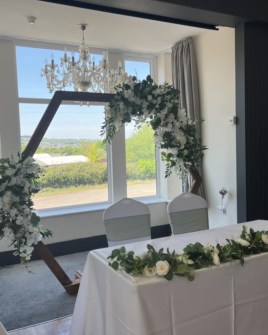 Geometric floral arbor for intimate wedding ceremony or sweetheart table at The Mill House.