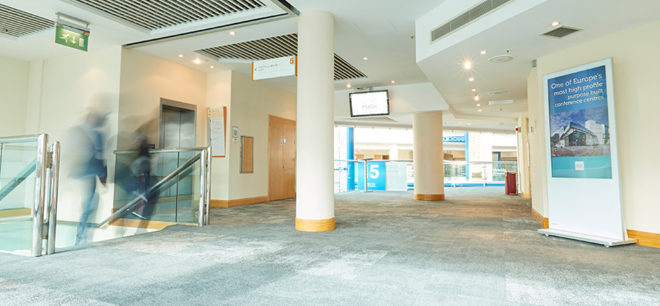 Spacious conference lobby at ICC Birmingham, modern design, ideal for networking events.