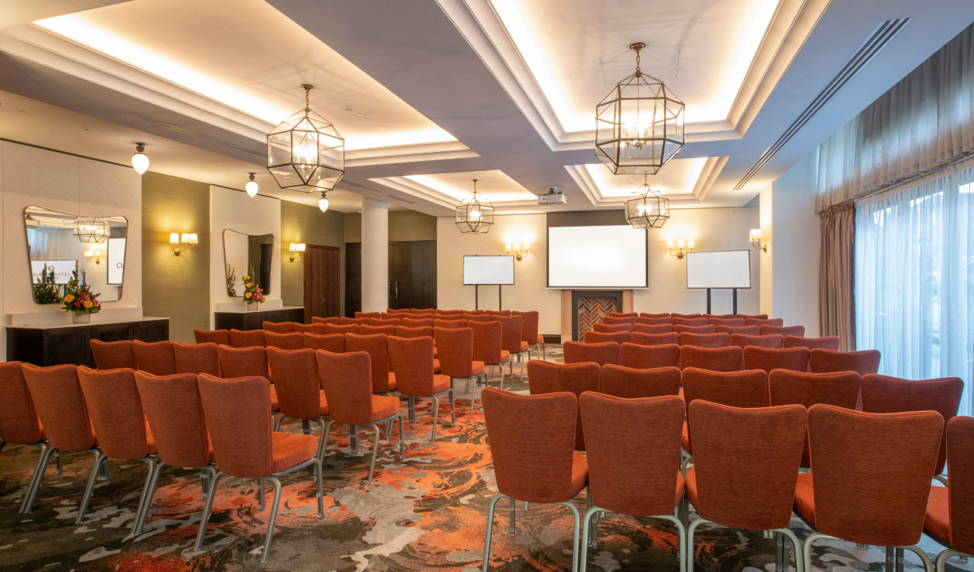 Marlowe Suite at Clayton Hotel Cambridge: modern meeting room with orange chairs for presentations.
