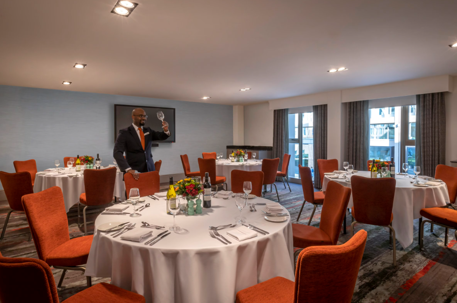 Elegant Marlowe Suite with round tables, perfect for corporate meetings or celebrations.