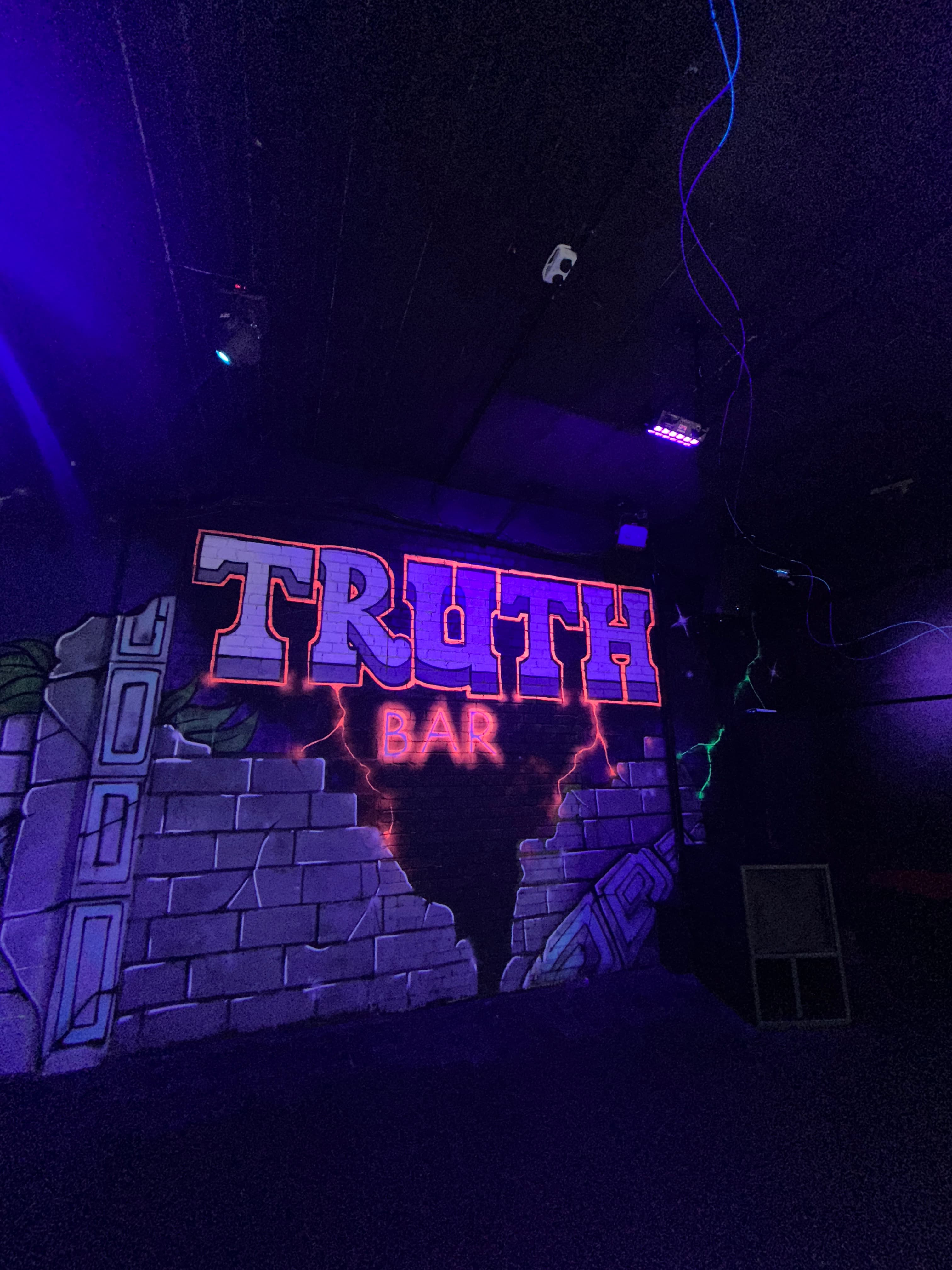 Truth Bar LDN: neon-lit venue for evening receptions and vibrant networking events.
